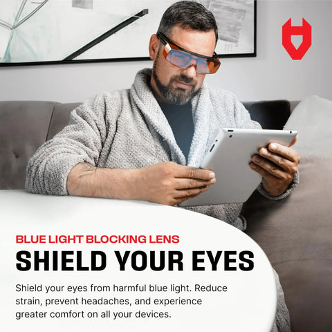 Man wearing Blue Light Blocking Glasses for Over Glasses With ANSI Z87 1 and UV Protection while using a tablet