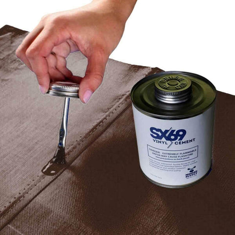 Hand applying 4oz SX-69 adhesive from a can onto a surface, part of the Vinyl Repair Kit For Inflatables With 12x60 Inch Blue Marble Patch Roll