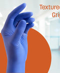 Blue nitrile glove with textured grip in a clinical setting. Non Latex Powder Free Nitrile Exam Gloves 100 Count Disposable Medical Grade.