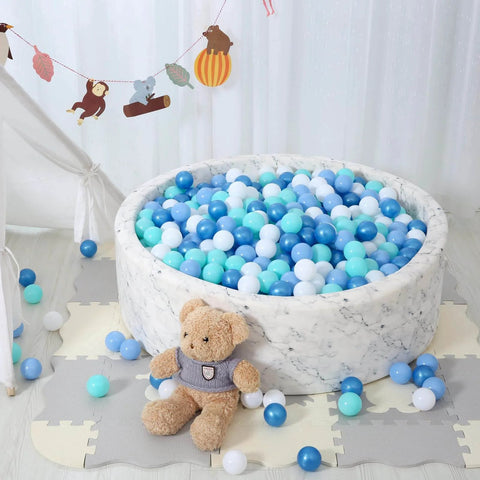 Ball pit with blue and white plastic play balls for kids, featuring a teddy bear and decorative background. Phthalate Free BPA Free 100pcs.