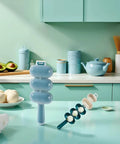 Blue Rice Ball Maker Shake And Mold Kit displayed on kitchen counter with shaker and mold components visible.