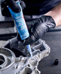 Applying Auto Grade RTV Silicone Gasket Maker Blue 587 Pro Grade High Temp Oil Resistant Sensor Safe Non Corrosive Sealant on engine