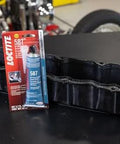 Auto Grade RTV Silicone Gasket Maker Blue 587 Pro Grade High Temp Oil Resistant Sensor Safe Non Corrosive Flexible Sealant For Engine Gaskets And Vehicle Repairs 80 Ml 1 Pack shown with engine part.