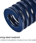 Close-up of blue light load steel die spring with 25mm outer diameter for 3D printers, emphasizing rust-resistant coating.