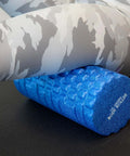 High Density Foam Roller Massager With 3D Textured Rollers for deep tissue back and leg muscle massage under legs in workout gear.
