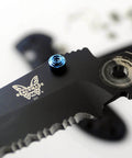 Close-up of blue titanium thumb stud installed on a black 535 Bugout blade, part of the ZYAMY 3pcs Thumb Studs Replacement set.