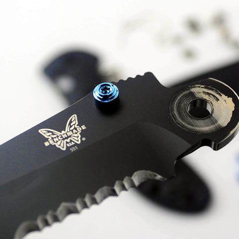 Close-up of blue titanium thumb stud installed on a black 535 Bugout blade, part of the ZYAMY 3pcs Thumb Studs Replacement set.