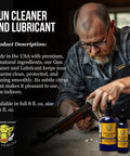 Man cleaning gun, bottles of Premium Gun Cleaner And Lubricant CLP Spray for Metal Surfaces on table.