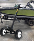 12 Inch Flat Free Solid Polyurethane Tire and Wheel on trailer dolly next to boat, black all-purpose replacement with 1 inch bore