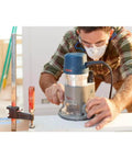 Woodworker using Bosch 1617EVSPK Combo Router With Plunge And Fixed Base, 2.25 HP Motor, 8,000 to 25,000 RPM, Quick Clamp Base Swap