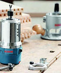 Fixed Base Router 2.25 HP 12 Amp Variable Speed 8000 to 25000 RPM for precise edge work on a workbench with accessories