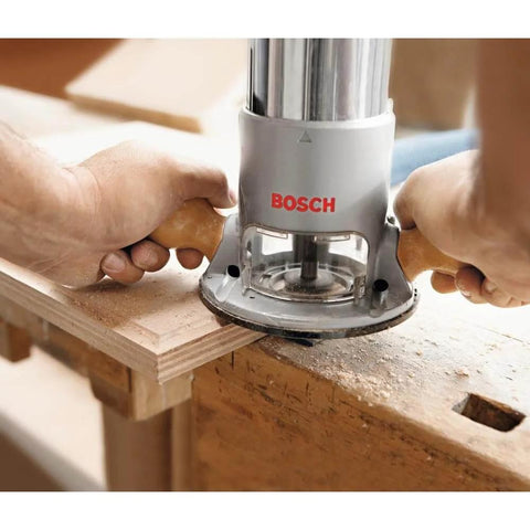 Person using Bosch fixed-base router on wood, highlighting precise edge work with Fixed Base Router 2.25 HP 12 Amp Variable Speed 8000 to 25000 RPM.