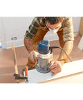 Person using 1617EVSPK Combo Router With Plunge And Fixed Base, 2.25 HP Motor, 8,000 to 25,000 RPM on woodworking project