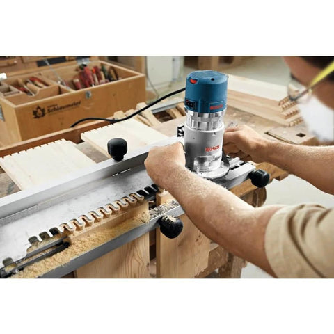 Person using Fixed Base Router 2.25 HP 12 Amp Variable Speed 8000 to 25000 RPM for precise edge work and mortising on wood.