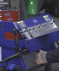 24 Inch Box And Pan Sheet Metal Brake With Five Adjustable Fingers for Small Shops shown in a workshop setting, bending metal.
