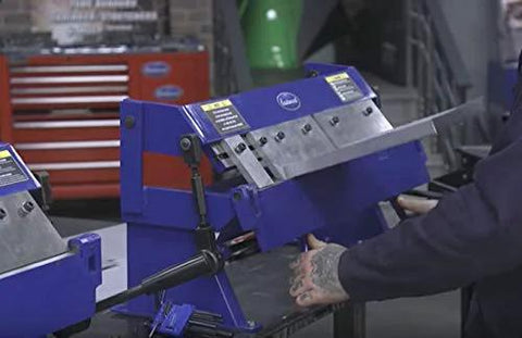 24 Inch Box And Pan Sheet Metal Brake With Five Adjustable Fingers for Small Shops shown in a workshop setting, bending metal.