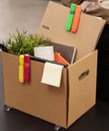 Cardboard box with 8Pcs 1/2 Inch Small Caster Wheels 360 Degree Swivel Casters, holding office supplies and a small plant