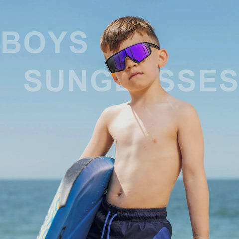 Boy wearing UV400 sunglasses at the beach, part of Three Pack Kids Sunglasses UV400 For Ages 6 To 14 Black Blue White.