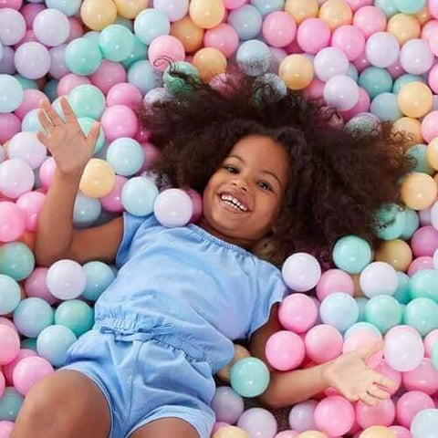 Child playing in BPA Free Crush-Proof Plastic Ball Pit Balls in 6 pastel colors