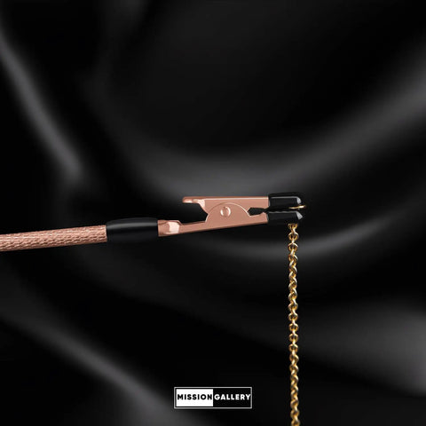 Bracelet Fastener Helper Tool With Hook For Bracelet Necklace Jewelry And Watch Clasp Clip Grab And Go Portable Easy To Use No Slip Grip Made Of Durable Metal With Rose Finish shown holding a chain.