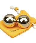 Brass Balls For Hand Exercise - 1.5 Inch Copper Balls - Boost Grip & Finger Strength - Smooth & Portable Hand Therapy Tools - Ideal For Stress Relief & Fitness, shown on a yellow cloth bag