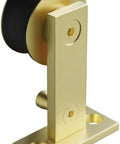 Close-up of single roller component in champagne brass from Seventy Eight And Three Quarters Inch Single Roller Round Rod Barn Door Hardware Kit.