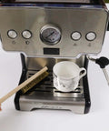 Soft Brass Bristle Wire Brush for Cleaning Metal Rust placed on a coffee machine tray next to a teacup, showing use for kitchen tasks