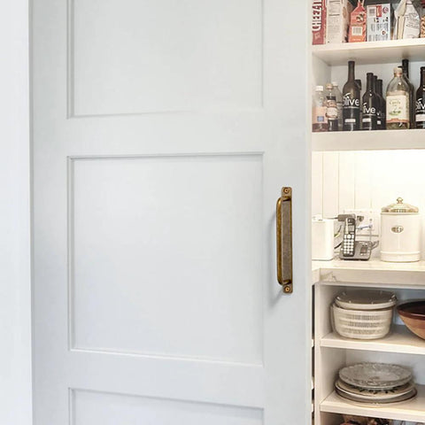 Set Of 12 Antique Brass Cabinet Pulls With Back Plates, Center To Center 5 Inch Length, installed on white cabinet door