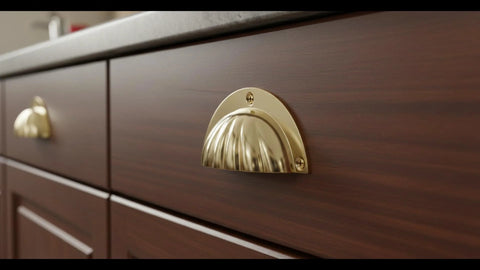 Brass Cup Handle With Elegant Scalloped Shell Design Pack Of 4 for drawer and cabinet pulls in a side view installed on wooden cabinet