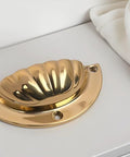 Brass Cup Handle With Elegant Scalloped Shell Design Pack Of 4 on cabinet surface, durable brass construction with smooth edges.
