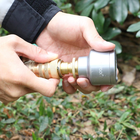 Hands connecting the No Hassle Full Flow Brass Garden Hose Quick Release Adapter Fitting With Male And Female Connectors