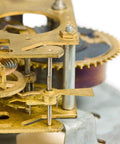Close-up of clockwork mechanism showing brass gears and metal rods for DIY crafts and modeling projects
