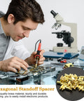 Man using soldering tool on motherboard with M3 Brass Hex Standoff Spacers Set For PC Build And Motherboard 50 Pieces With Male To Female Threads 9mm And 4mm Lengths Durable PCB Hardware Kit With Nuts And Screws Uxcell.