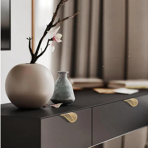 Leaf Shaped Cabinet Handles Set, Solid Brass With Brushed Gold Finish, 2 Pack Vanity Drawer Pulls installed on black cabinet