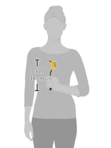 Person holding a Brass Mini Brush for Cleaning with Soft Grip, 1/2 inch, Yellow/Grey, shown alongside a scale of 7.3 inches.