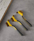 Top view of Brass Mini Brushes for Cleaning, Soft Grip, 1/2 inch, Yellow/Grey, 3-Pack on a workshop table