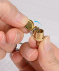 Spring Brass L Shape Oil Cup Cap Set for Lathe Machines, M12x1.25 Thread, shown opened in hand, BE TOOL Oiler Accessories