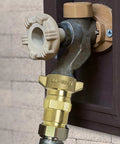 Brass RV Water Pressure Regulator With Filter Screen for Campers and Travel Trailers installed on a water outlet