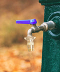 Brass RV Water Pressure Regulator with filter screen installed on outdoor pipe, 40-50 PSI control for campers and travel trailers.