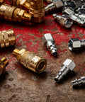 M-Style One Quarter Inch Male NPT Air Quick Connect Coupler For Industrial Use with Kwik-Change fittings on metal surface
