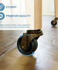 Close-up of brass stem caster with rubber wheel installed on furniture, highlighting safe use on hardwood floors.