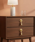 Two Pack Solid Brass Cabinet Knobs And Tear Drop Pendant Pulls In Brushed Gold Finish installed on a wooden drawer