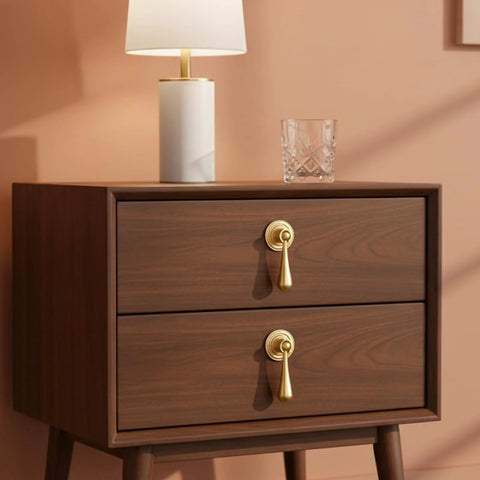 Two Pack Solid Brass Cabinet Knobs And Tear Drop Pendant Pulls In Brushed Gold Finish installed on a wooden drawer