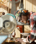Person wearing Brazeau Polarized Safety Glasses With 99.9 Percent UV Protection And ANSI Z87 working with a saw outdoors.