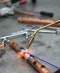 Brazing with AWS BAg7 Silver Brazing Rods Flux Coated Solder Kit Pro Grade, showing welding process on metal pipes.
