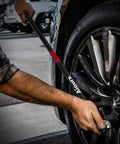 Person using Heavy Duty Half-Inch Drive 25-Inch Breaker Bar With 250-Degree Swivel Head Aiourx CR-MO Chrome Molybdenum Steel Extension on car wheel