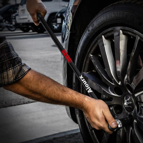Person using Heavy Duty Half-Inch Drive 25-Inch Breaker Bar With 250-Degree Swivel Head Aiourx CR-MO Chrome Molybdenum Steel Extension on car wheel