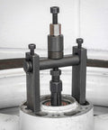 10pc Bridge Bearing Puller Set installed on machinery, demonstrating bearing removal process with screw-type extractor and collet grips