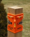 GloOrange Post Level With Hands Free Operation Provides Precise Leveling And Plumb Readings Using A Bright Orange ABS Body And A Secure Rubber Strap Ideal For One Person Setup On Posts Pipes Fences Decks And Rails installed on a wooden post