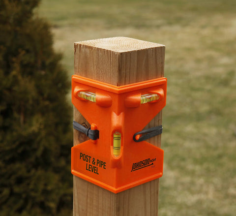 GloOrange Post Level With Hands Free Operation Provides Precise Leveling And Plumb Readings Using A Bright Orange ABS Body And A Secure Rubber Strap Ideal For One Person Setup On Posts Pipes Fences Decks And Rails installed on a wooden post